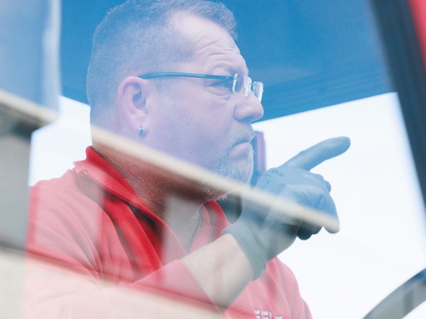 Mann in LKW zeigt mit Finger um auf etwas hinzuweisen